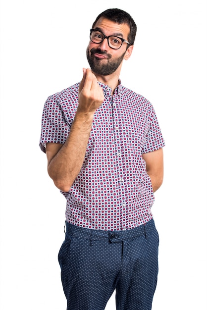 Man with glasses doing money gesture