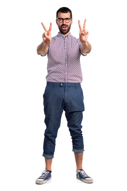 Man with glasses doing victory gesture