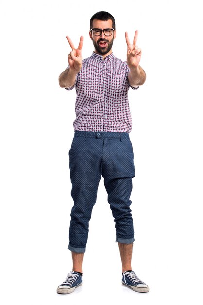 Man with glasses doing victory gesture