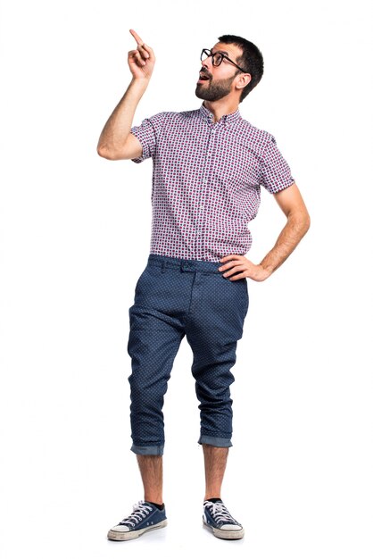 Man with glasses pointing up