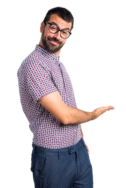 Man with glasses presenting something