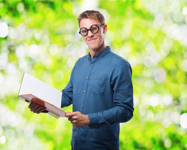 Man with glasses to see reading a notebook