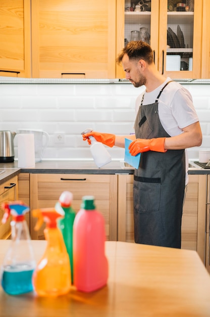 Man with gloves holding bottle