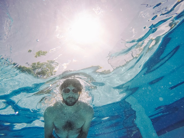 Man with goggles diving