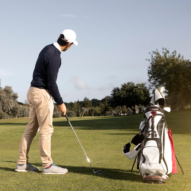 Man with golf club on the field playing