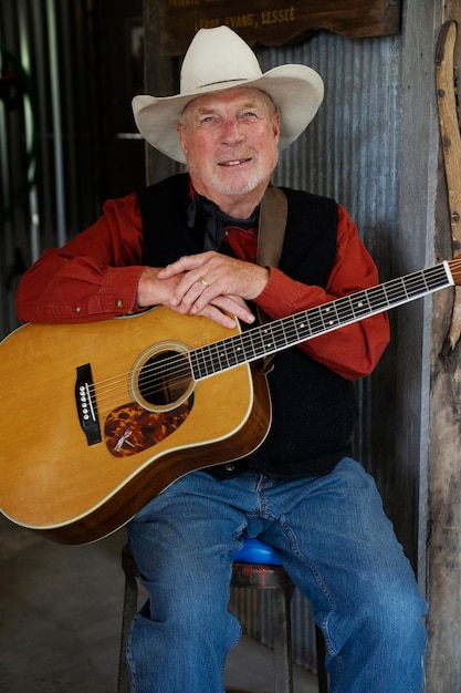 Free photo man with guitar getting ready for country music concert