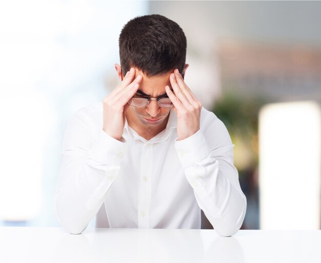 Man with headache with hands on temples