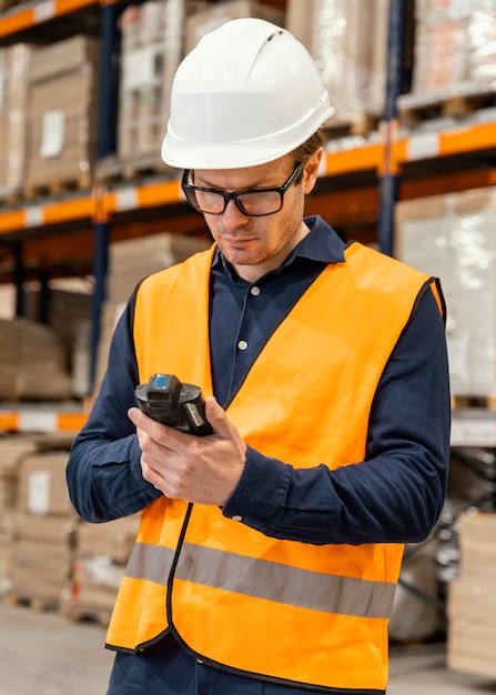 Free photo man with helmet in warehouse