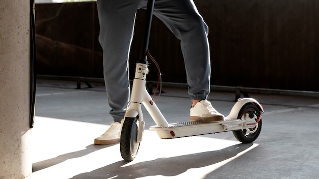 Man with his scooter in a parking lot indoors