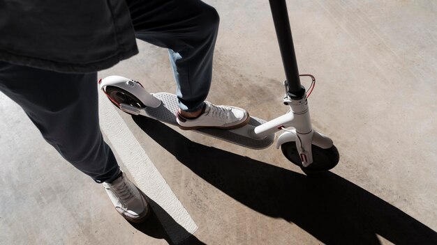 Man with his scooter in a parking lot indoors