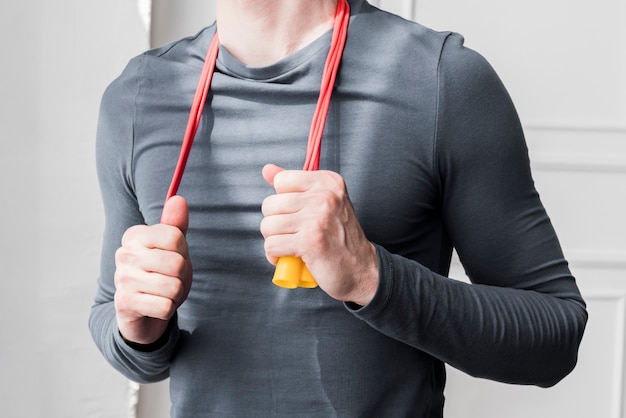 Man with jumping rope on neck