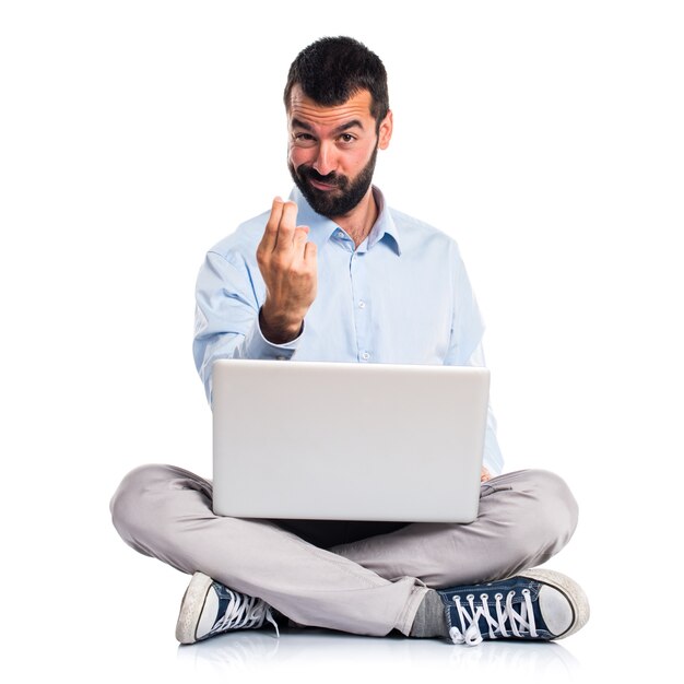 Man with laptop coming gesture