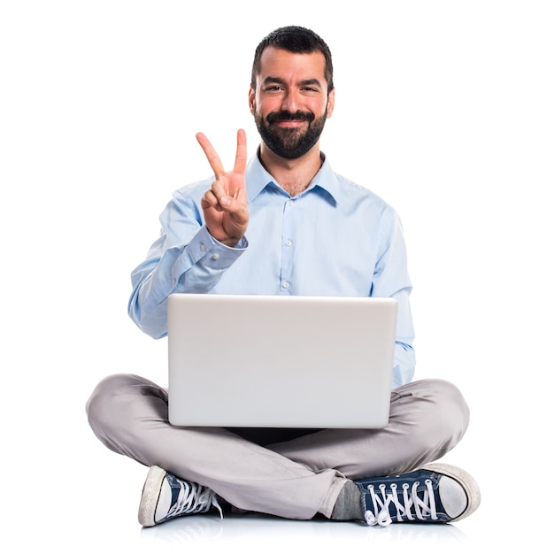 Man with laptop counting two