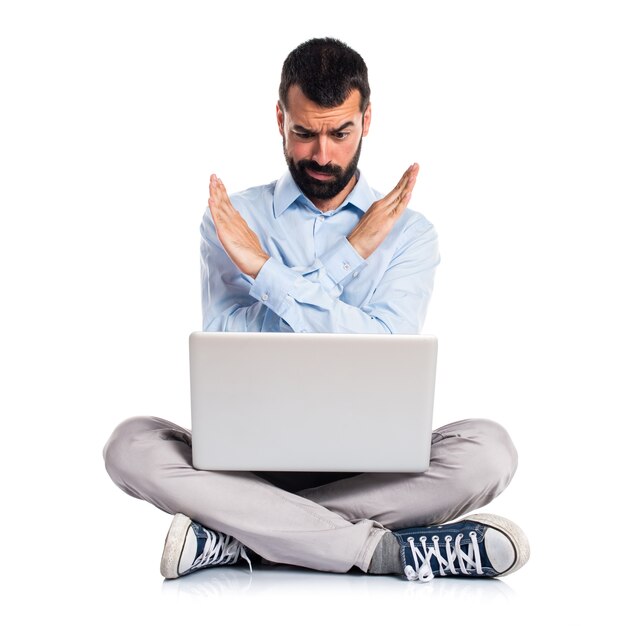 Man with laptop doing NO gesture