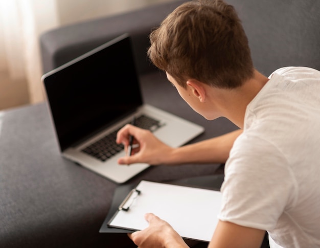 Man with laptop at home in quarantine working