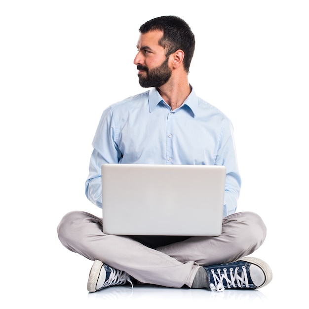 Man with laptop looking lateral