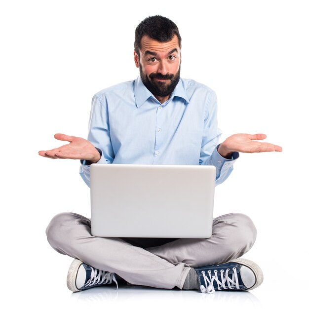 Man with laptop making unimportant gesture