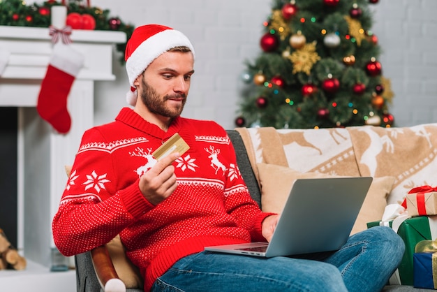 Man with laptop and plastic card