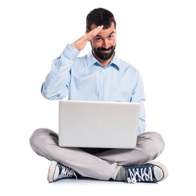 Man with laptop saluting