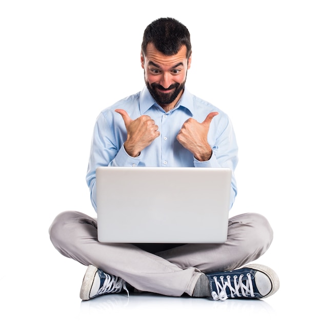 Man with laptop with thumb up
