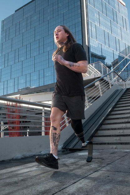 Man with leg disability running in the city