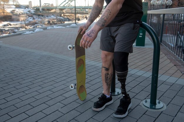 Man with leg disability skateboarding in the city