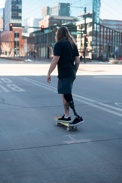 Man with leg disability skateboarding in the city