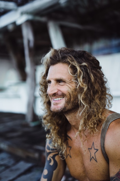 a man with long curly hair in a fishing location. fisherman on the ocean