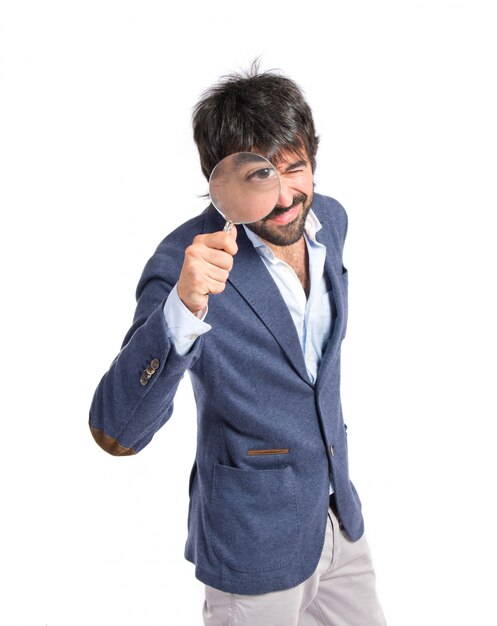 Man with magnifying glass over white background