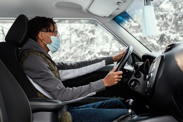 Man with mask driving