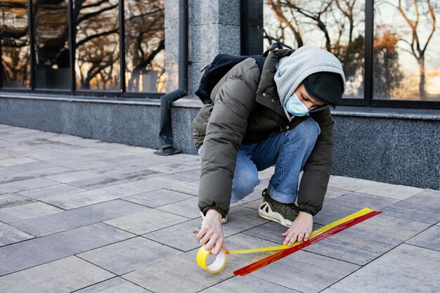 Man with mask setting social distance stripe