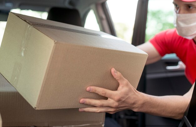 Man with mask taking box close-up