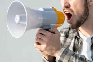 Free photo man with megaphone shouting