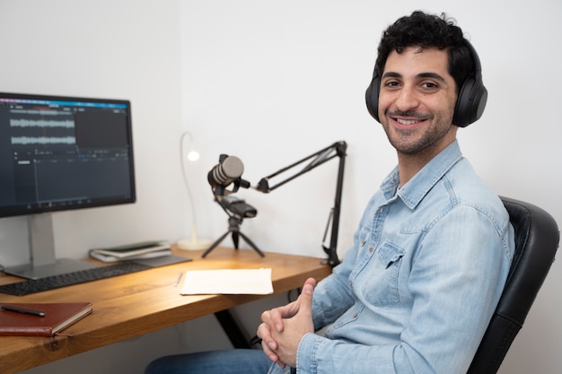 Man with microphone and headphones running a podcast in the studio