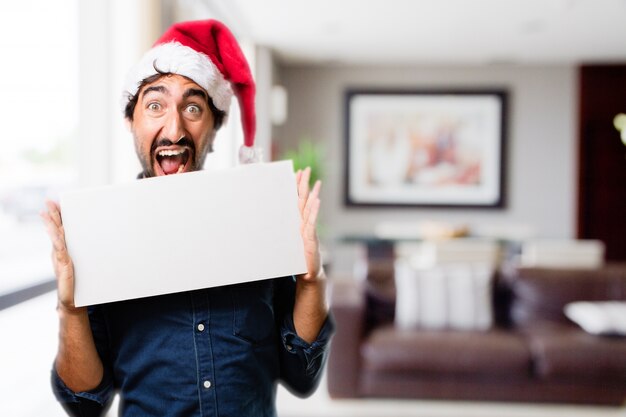 Man with mouth open holding a sign