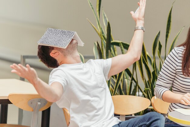 Man with notebook on his face