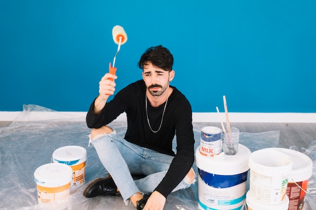 Man with paint materials