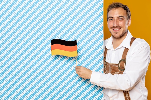 Free photo man with patterned blue sign and flag