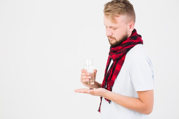 Man with pill in hand