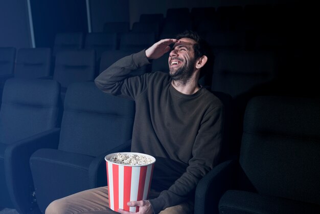 Man with popcorn in cinema