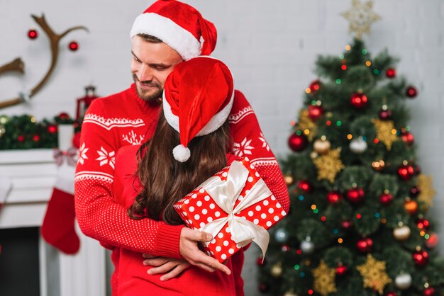 Man with present hugging woman 