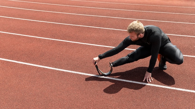 Man with prosthetic leg stretching full shot