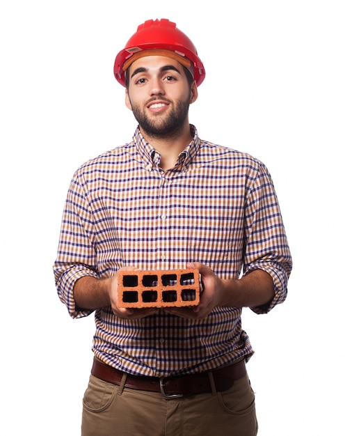 Man with a red helmet and a brick