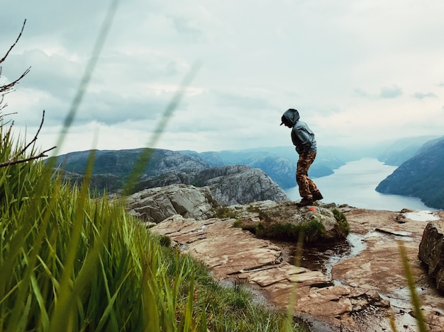 Free photo man with a rucksack admires gorgeous mountain landscape