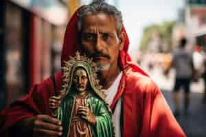 Free photo man with saint mary statue