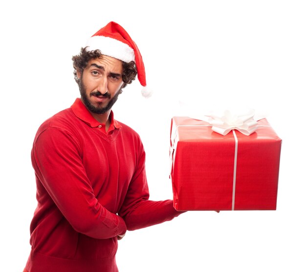 Man with santa's hat and a gift in a hand