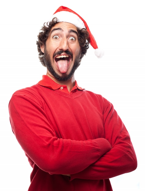 L'uomo con cappello di babbo natale che fa la toungue