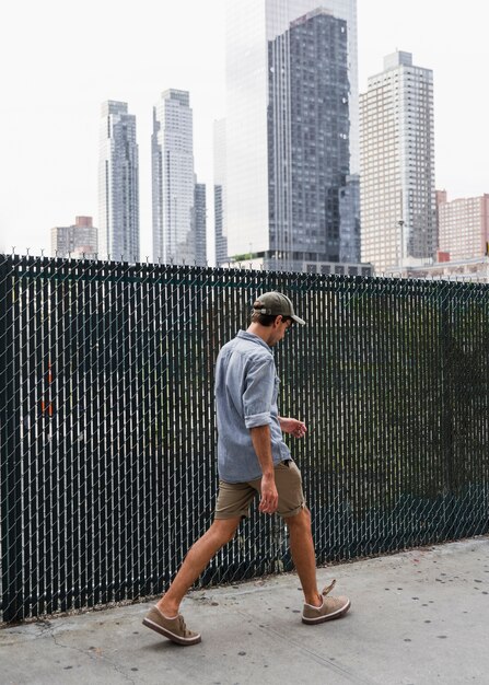 Man with shirt leaving somewhere in the city