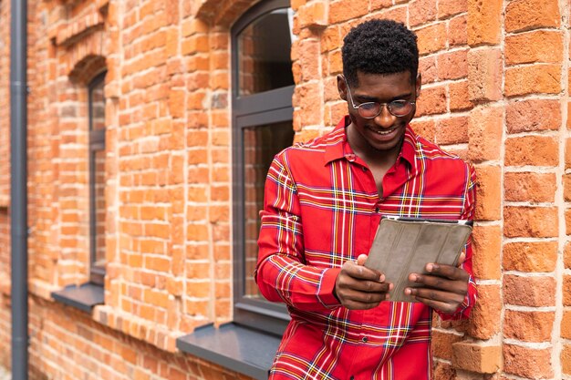 Man with short hair reading from his tablet