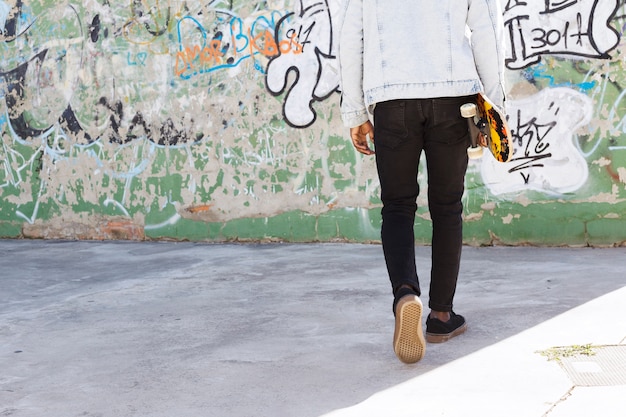 Man with skateboard in urban environment